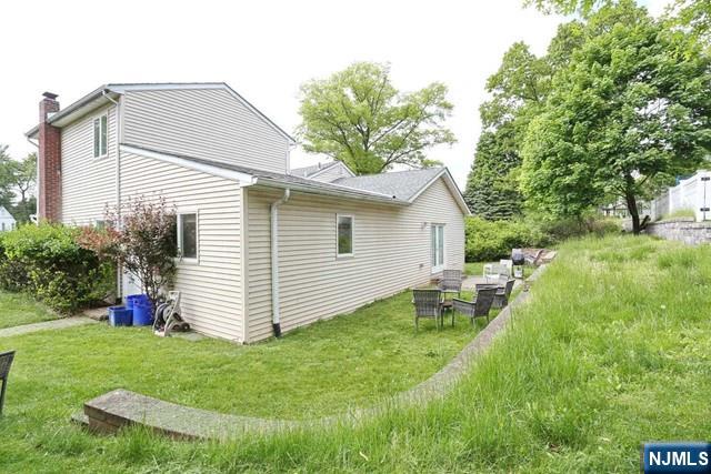 84 12th Street Cresskill, NJ 07626 - Photo 41 of 45 a view of a house with a yard and sitting area