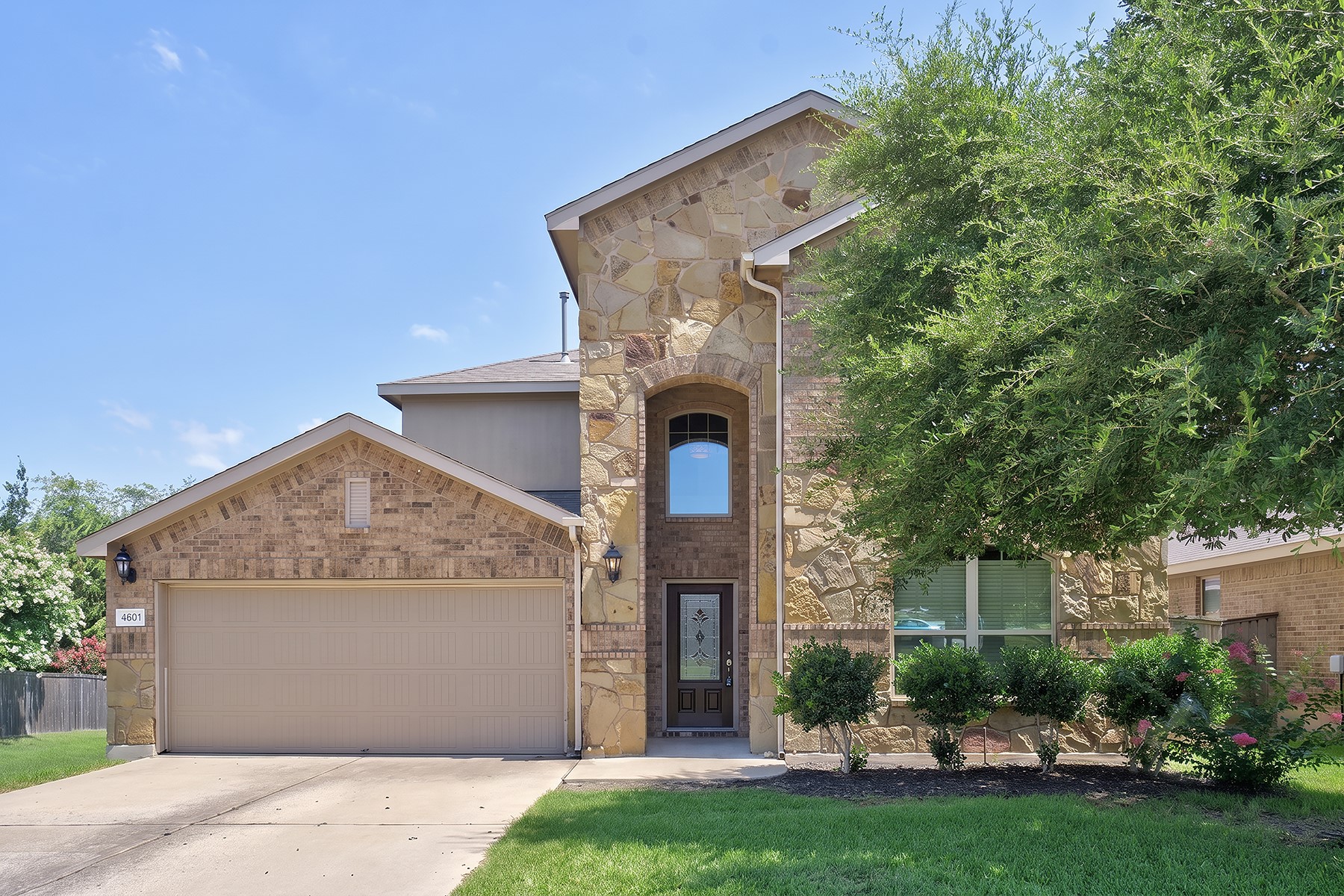 4601 Chestnut Meadows Bend Georgetown, TX 78626 - Photo 2 of 35 A striking exterior combines rich brick and natural stone, creating a distinguished curb appeal for this inviting residence.