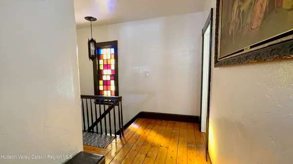 a view of a room with wooden floor and windows