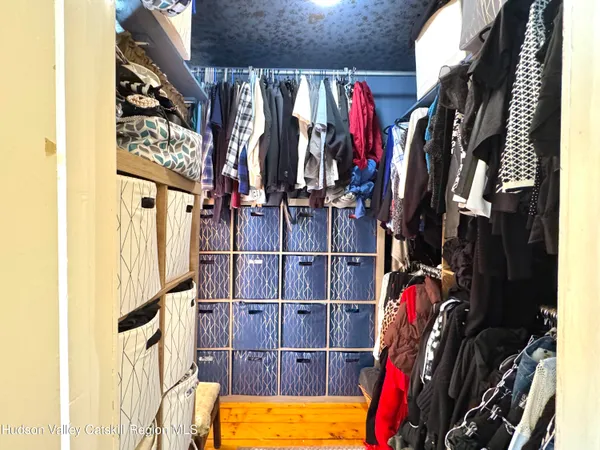 a view of a hallway with windows and closet