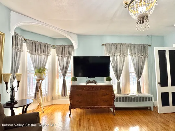 a living room with fireplace furniture and a chandelier