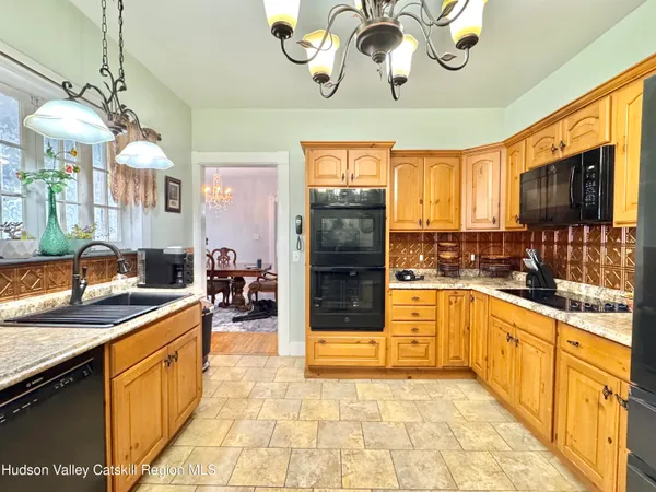 a kitchen with stainless steel appliances granite countertop a stove refrigerator and cabinets
