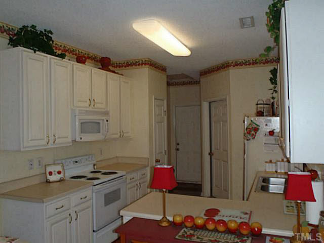 5832 Solitude Way Durham, NC 27713 - Photo 8 of 20 a kitchen that has a lot of cabinets and appliances in it