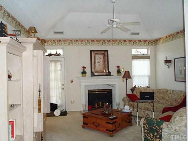 5832 Solitude Way Durham, NC 27713 - Photo 9 of 20 a living room with furniture and a fireplace