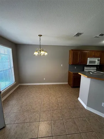 a view of a kitchen with microwave and cabinets
