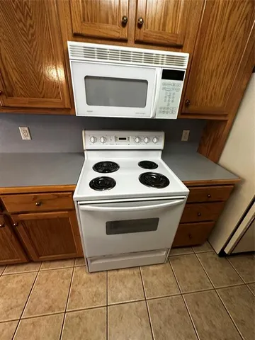 a stove top oven sitting inside of a kitchen