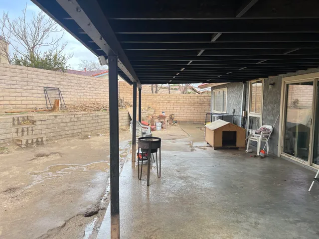 a view of a porch with furniture and next to a yard