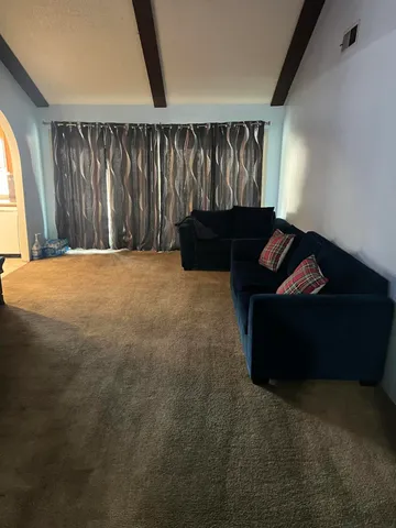 a living room with a couch and a window