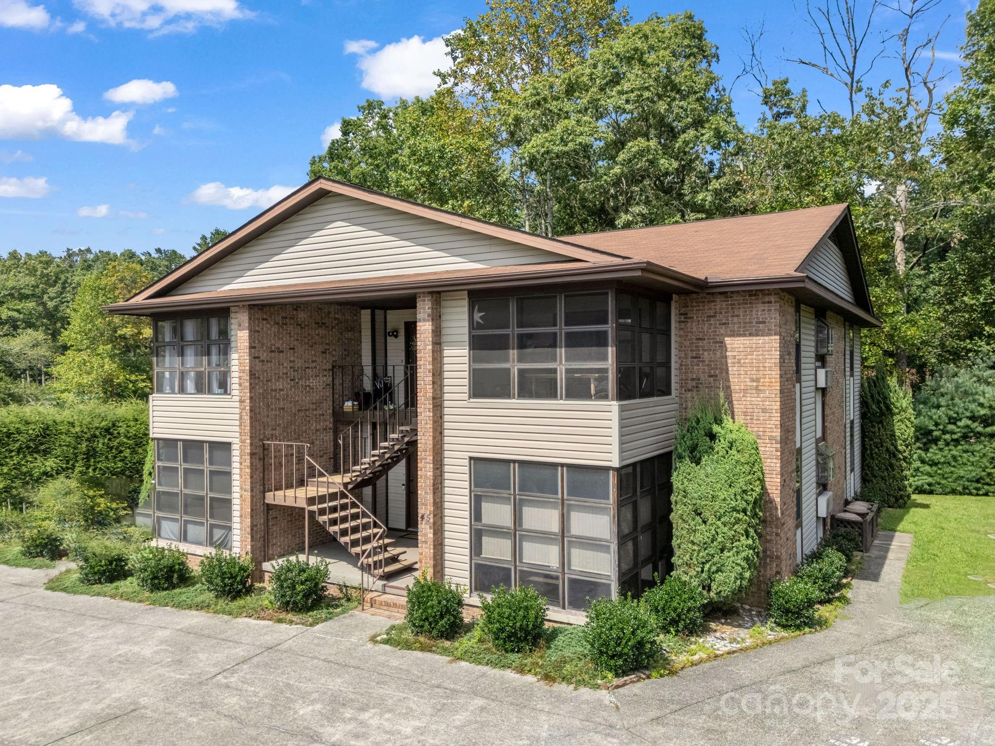 45 Indian River Road Hendersonville, NC 28791 - Photo 2 of 19 a front view of a house with a yard