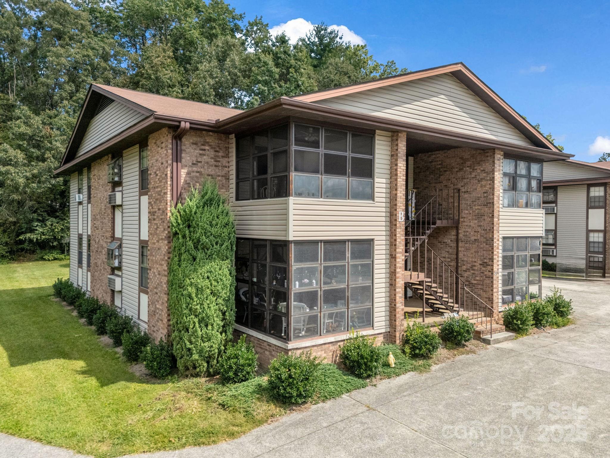45 Indian River Road Hendersonville, NC 28791 - Photo 3 of 19 a front view of a house with a garden