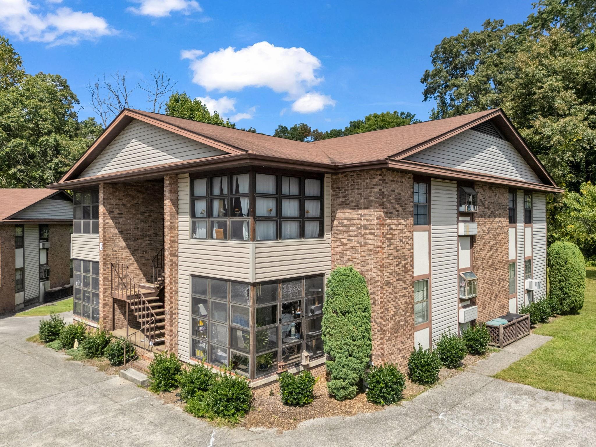 45 Indian River Road Hendersonville, NC 28791 - Photo 4 of 19 a front view of a house with garden