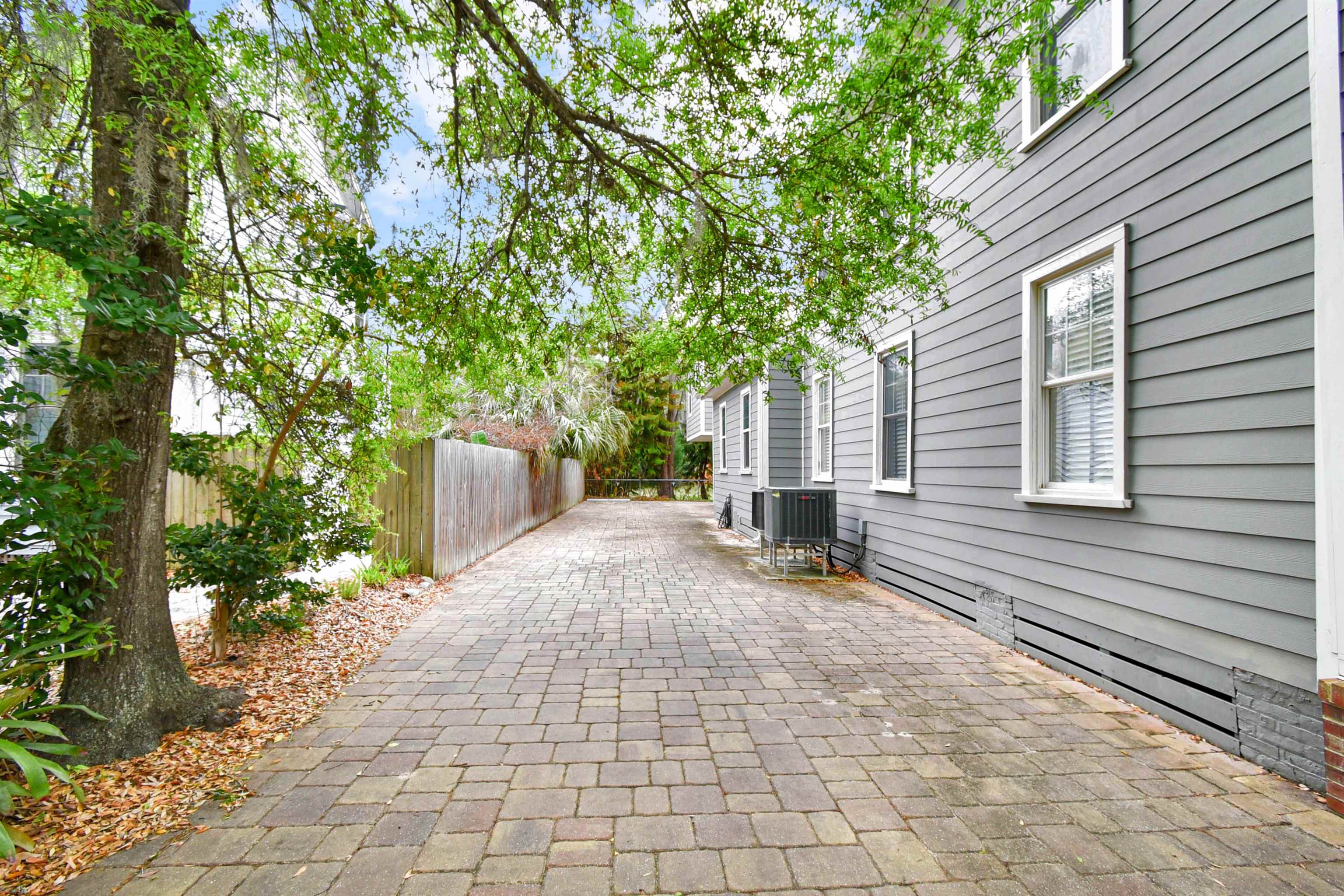 9 Sevilla Street St. Augustine, FL 32084 - Photo 25 of 75 a view of a patio with table and chairs and a large tree