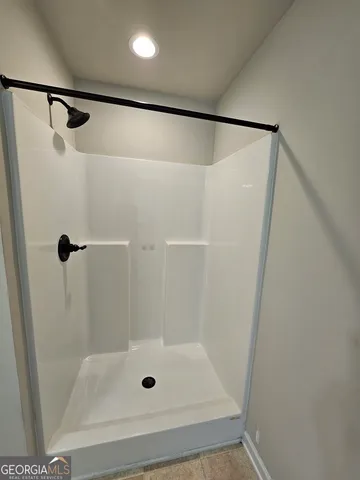 a bathroom with a shower and toilet