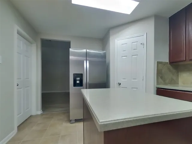 a kitchen with a wooden floor and white cabinets