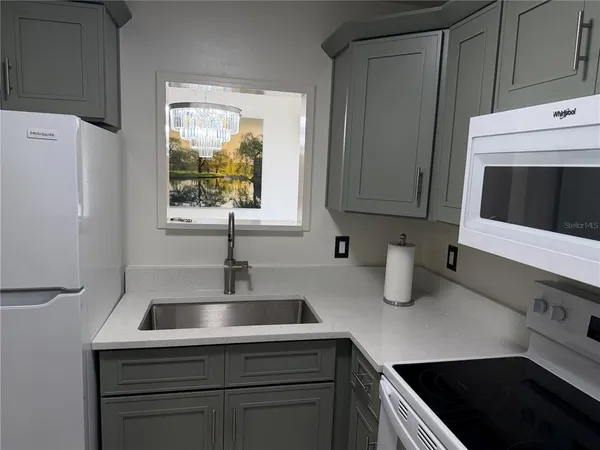 a kitchen with sink and cabinets
