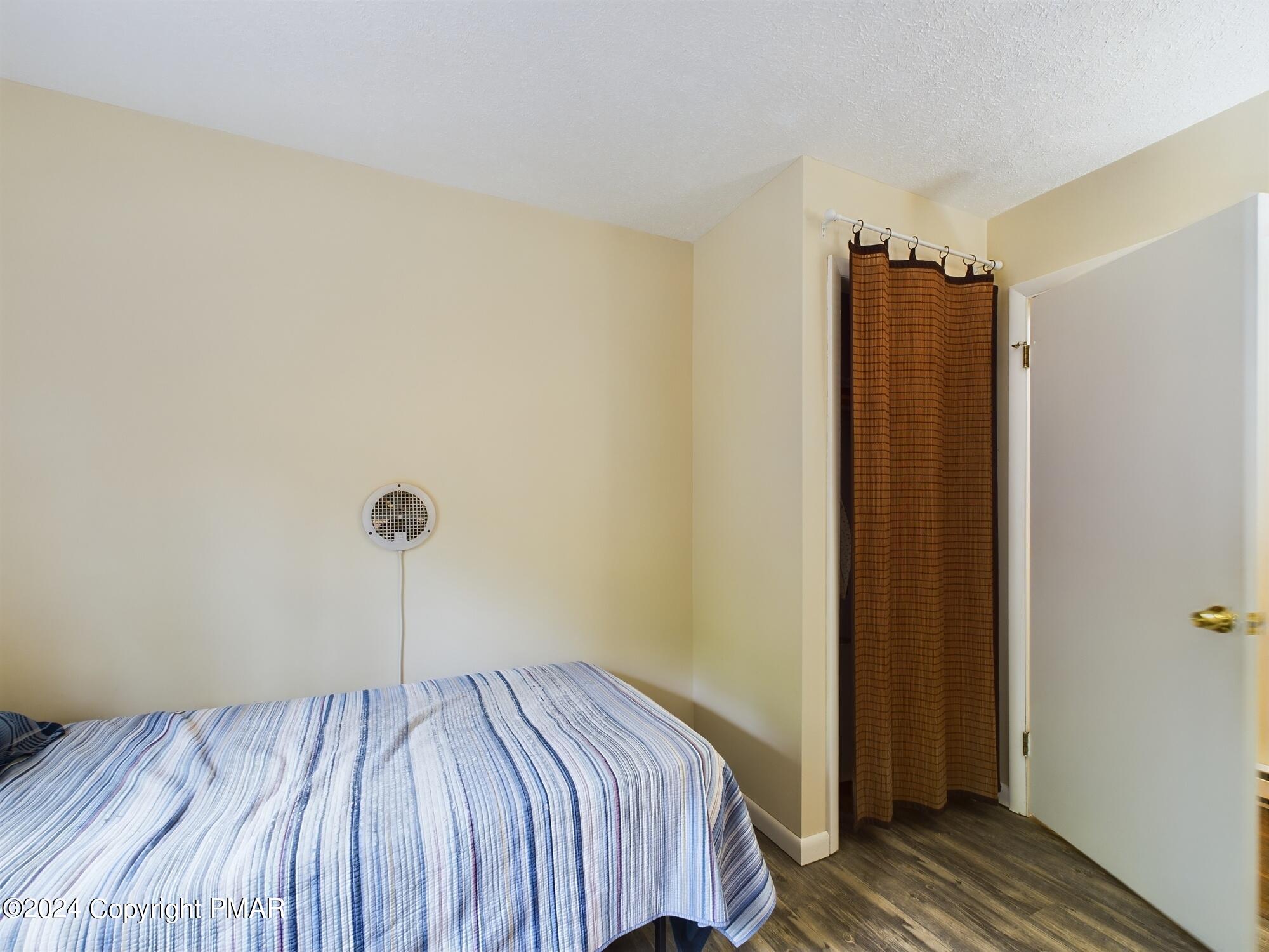 1245 Ranger Trail Pocono Lake, PA 18347 - Photo 22 of 59 a bedroom with a bed and wooden floor