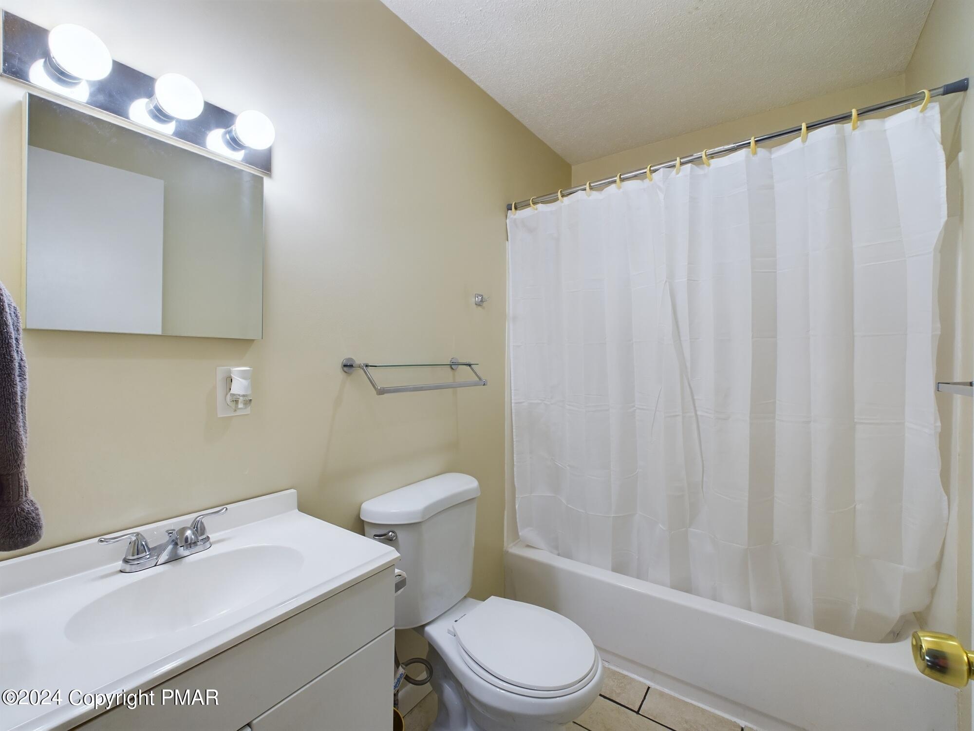 1245 Ranger Trail Pocono Lake, PA 18347 - Photo 36 of 59 a bathroom with a sink a toilet and shower curtain