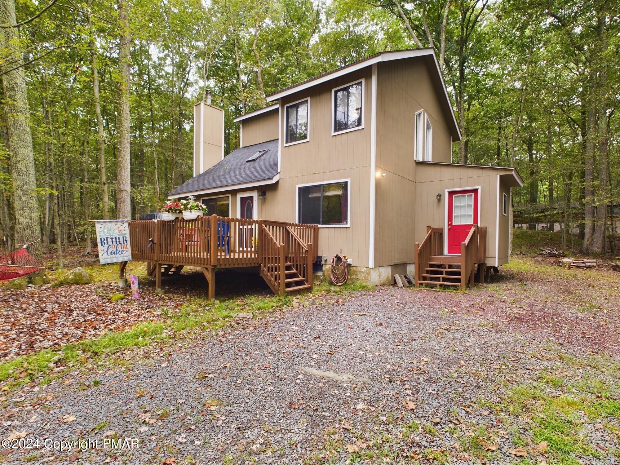 1245 Ranger Trail Pocono Lake, PA 18347 - Photo 52 of 59 a view of a house with a yard and large trees