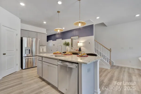 a kitchen with a sink a refrigerator and a stove