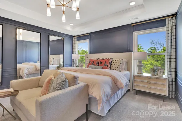 a spacious bedroom with a bed and a couch