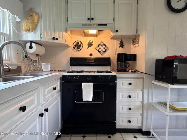 a kitchen with stainless steel appliances a stove a microwave and cabinets