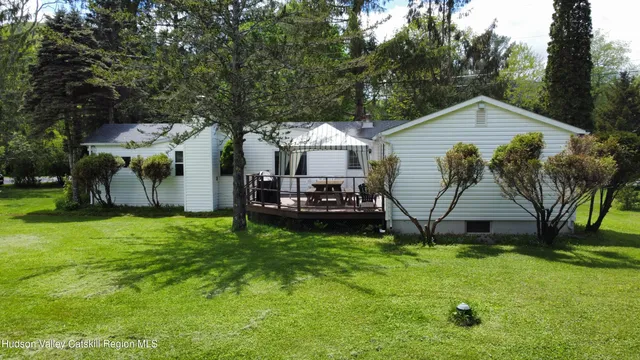 a view of a house with a yard and sitting area