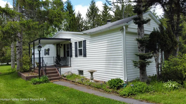 a view of a chair and table in backyard of the house