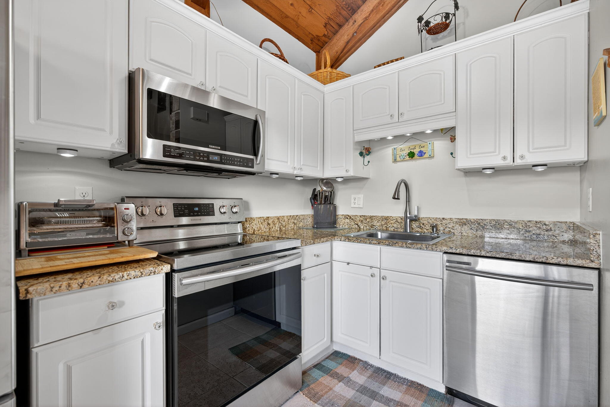1605 Highway 1, Unit 8E Jupiter, FL 33477 - Photo 10 of 47 a kitchen with stainless steel appliances granite countertop white cabinets a sink and a stove