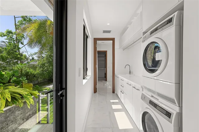 a view of a hallway with washer and dryer