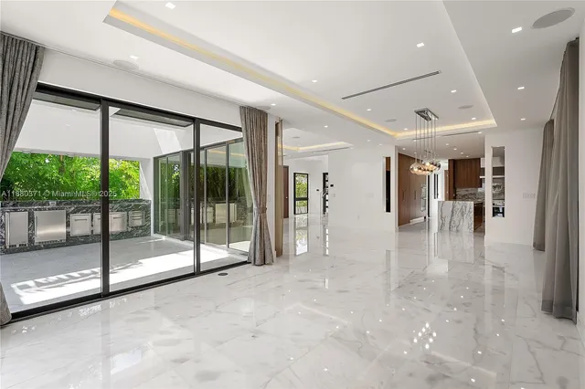 a view of a hall with floor to ceiling windows