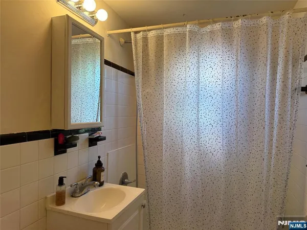 a bathroom with a shower and a sink