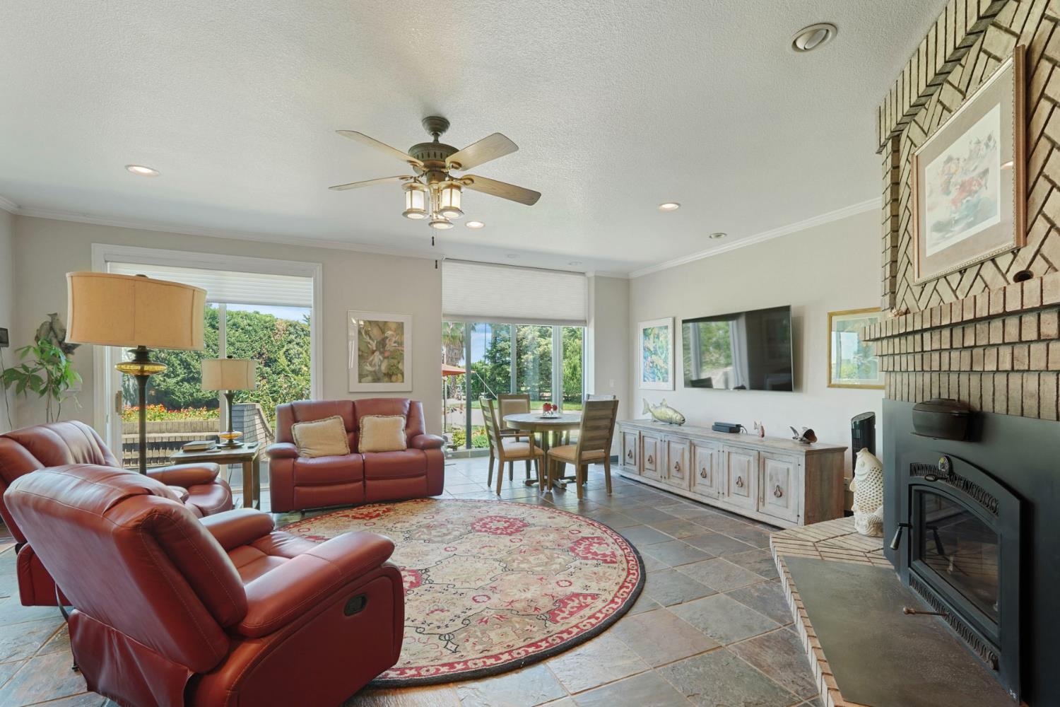 21649 Des Moines Road Acampo, CA 95220 - Photo 12 of 34 a living room with furniture a fireplace and a flat screen tv