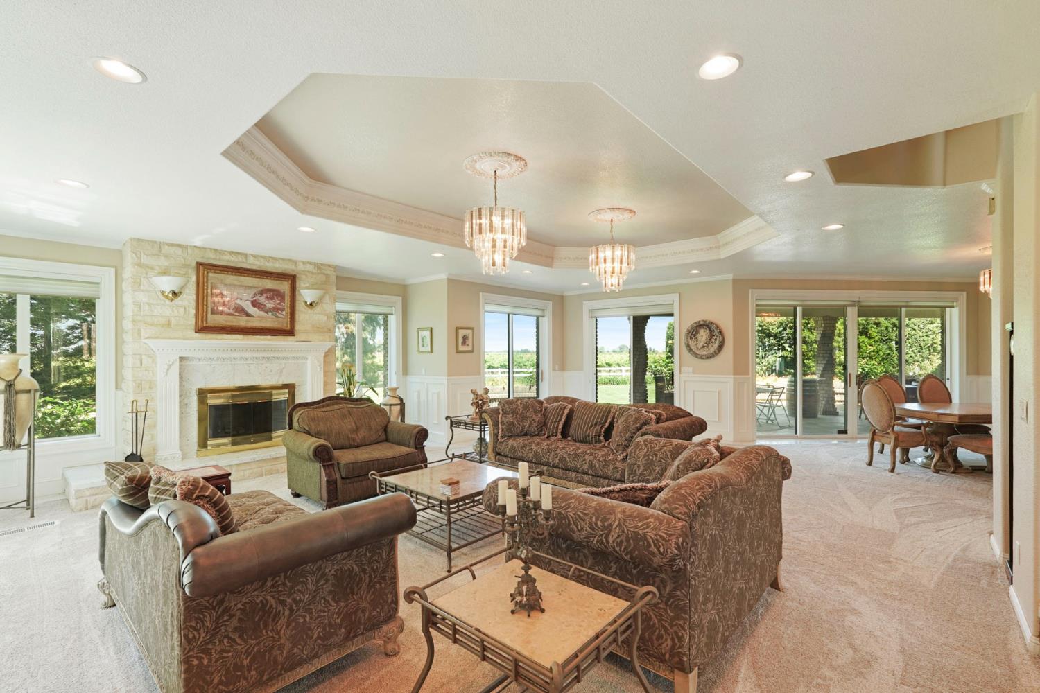 21649 Des Moines Road Acampo, CA 95220 - Photo 8 of 34 a living room with furniture ceiling fan and a fireplace