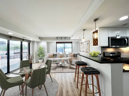 a living room with fireplace furniture and a large window