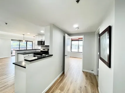 a kitchen with stainless steel appliances granite countertop a refrigerator and a stove top oven