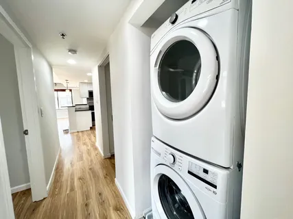 a view of a hallway with washer and dryer