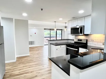 a kitchen with granite countertop a stove and a sink