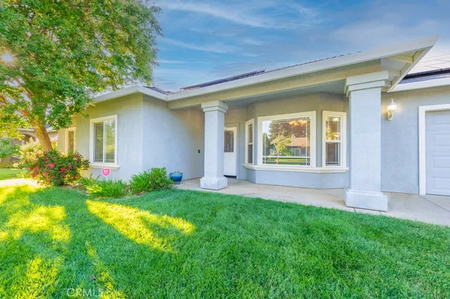 a view of house with backyard space and garden