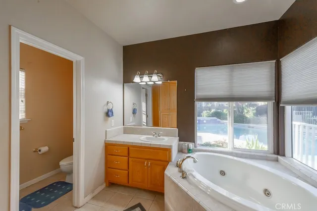 a bathroom with a bathtub sink and mirror