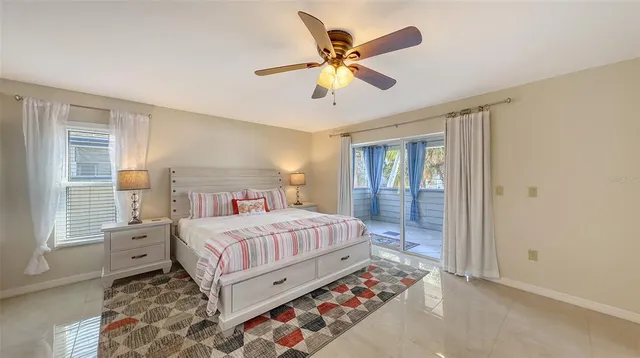 a spacious bedroom with a bed and a chandelier