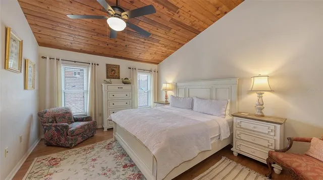 a open kitchen with stainless steel appliances granite countertop a stove a sink dishwasher and a dining table with wooden floor