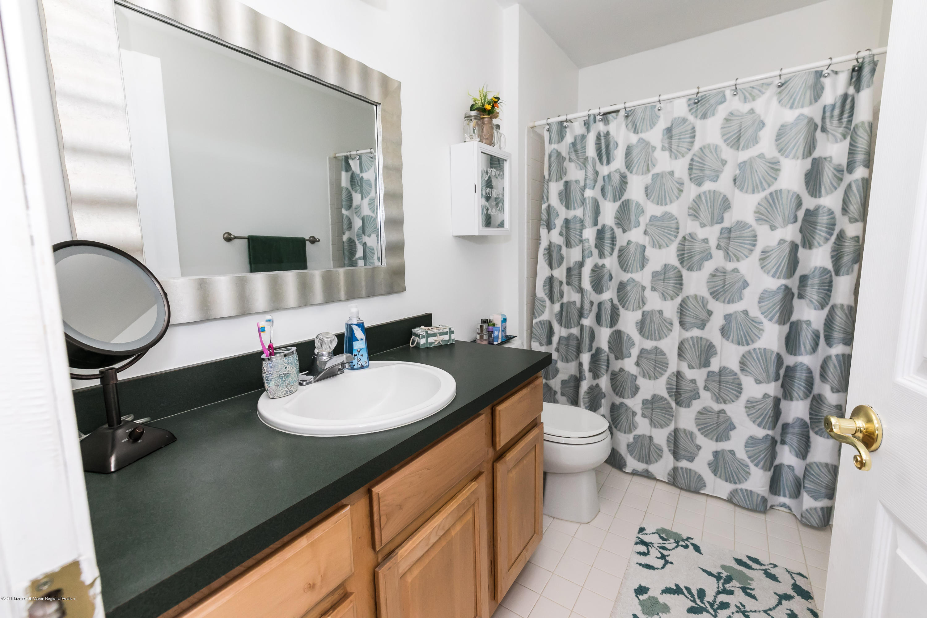 421 Diamond Road Jackson, NJ 08527 - Photo 17 of 24 a bathroom with a granite countertop sink and a mirror