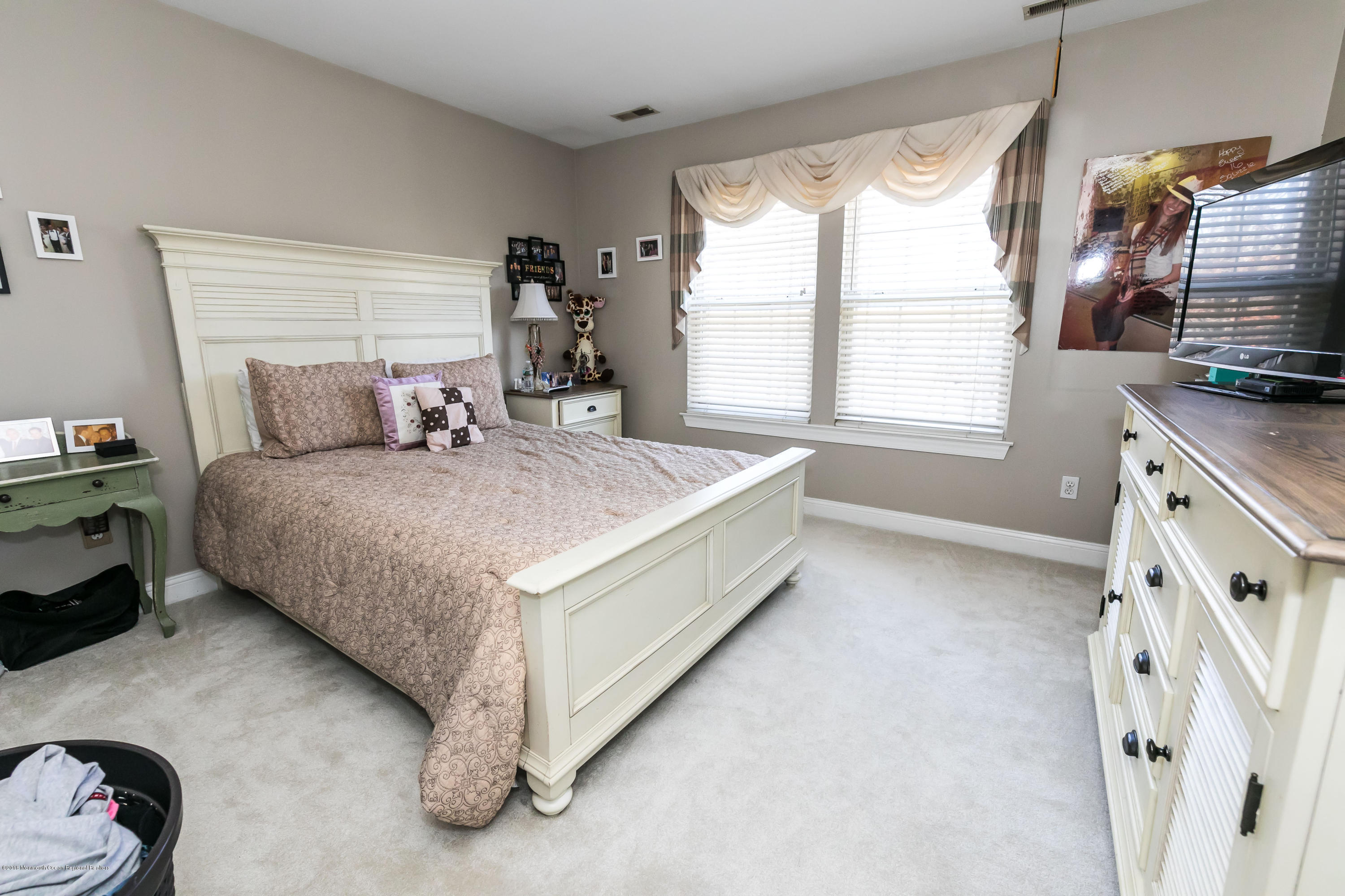 421 Diamond Road Jackson, NJ 08527 - Photo 18 of 24 a bedroom with a bed a flat screen tv and a window