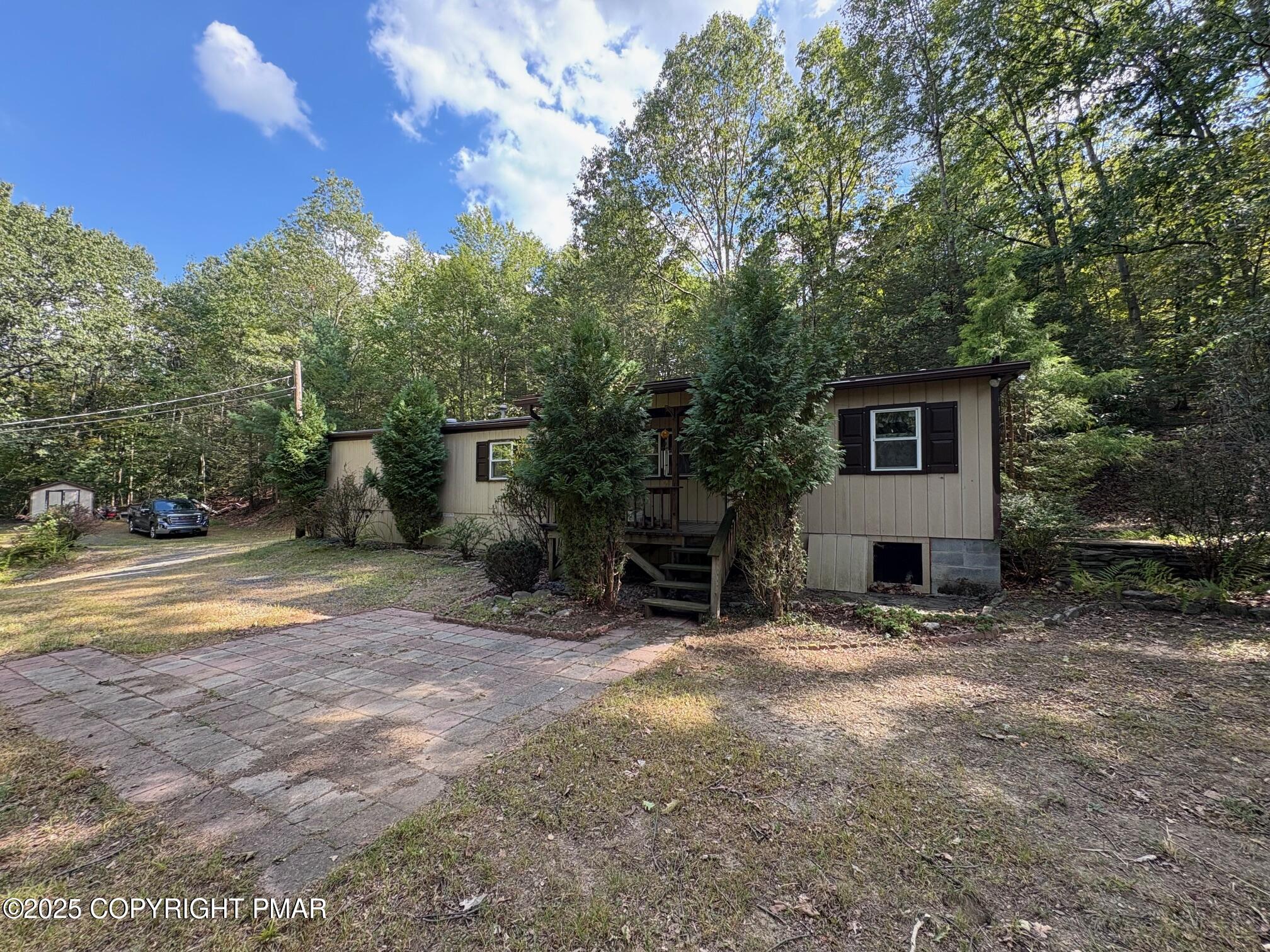197 Koehler Road Saylorsburg, PA 18353 - Photo 2 of 9 a view of backyard with outdoor seating and trees