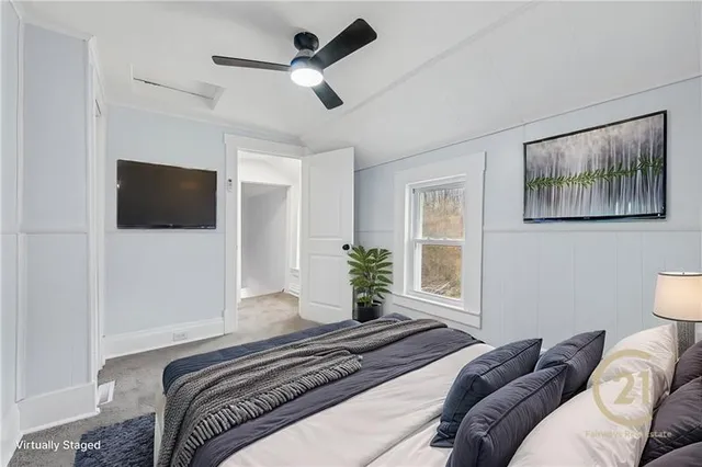 a bedroom with a bed furniture and a flat screen tv