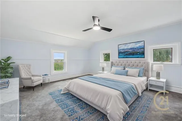 a spacious bedroom with a bed couch and a window