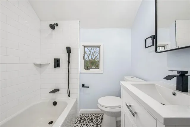 a white toilet sitting next to a bathroom sink