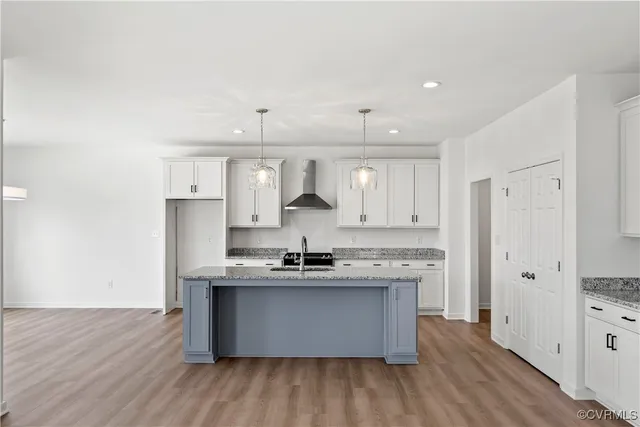 a kitchen with stainless steel appliances granite countertop a sink a stove and a refrigerator