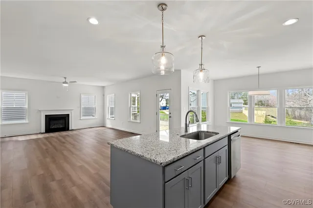 a kitchen with granite countertop a stove and a wooden floor