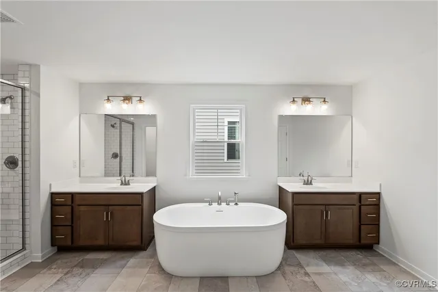a spacious bathroom with a double vanity sink a mirror and a bathtub